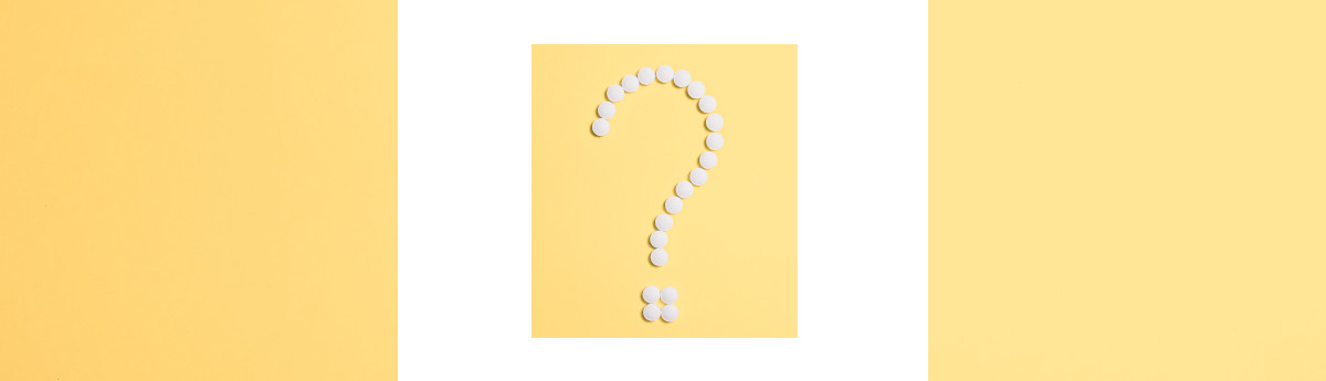 pills arranged in the shape of a question mark