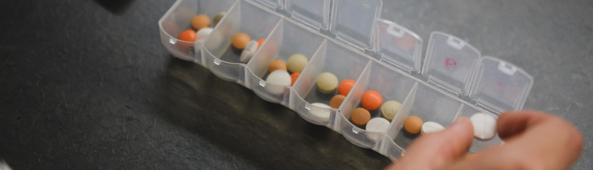 medication organizer full of multiple types of pills