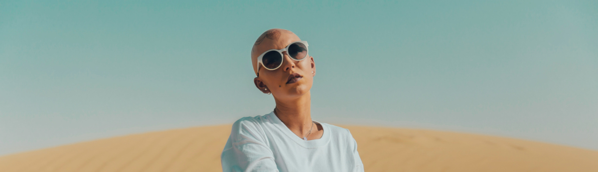 woman with no hair wearing sunglasses